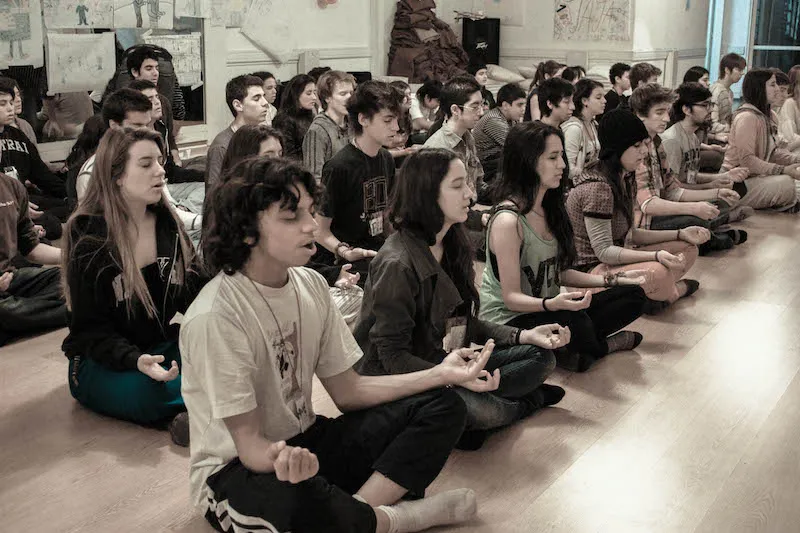Teens engaged in a mindfulness activity outdoors