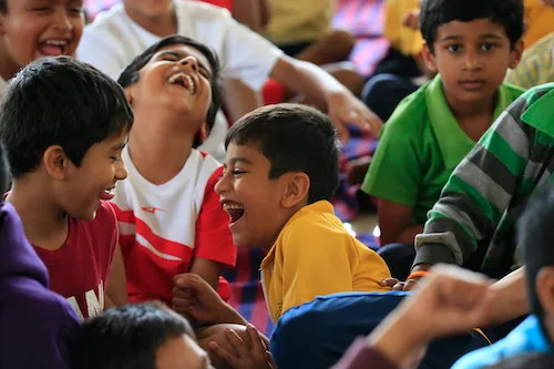 Young people laughing together during an ART Excel youth session